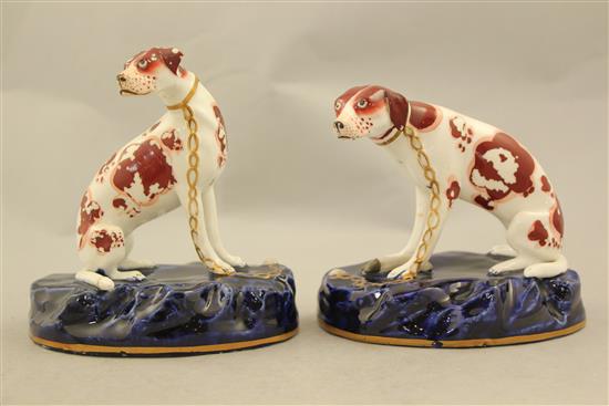 A pair of English porcelain figures of seated hounds, c.1830, 11.5cm and 12.5cm, flaking to enamels